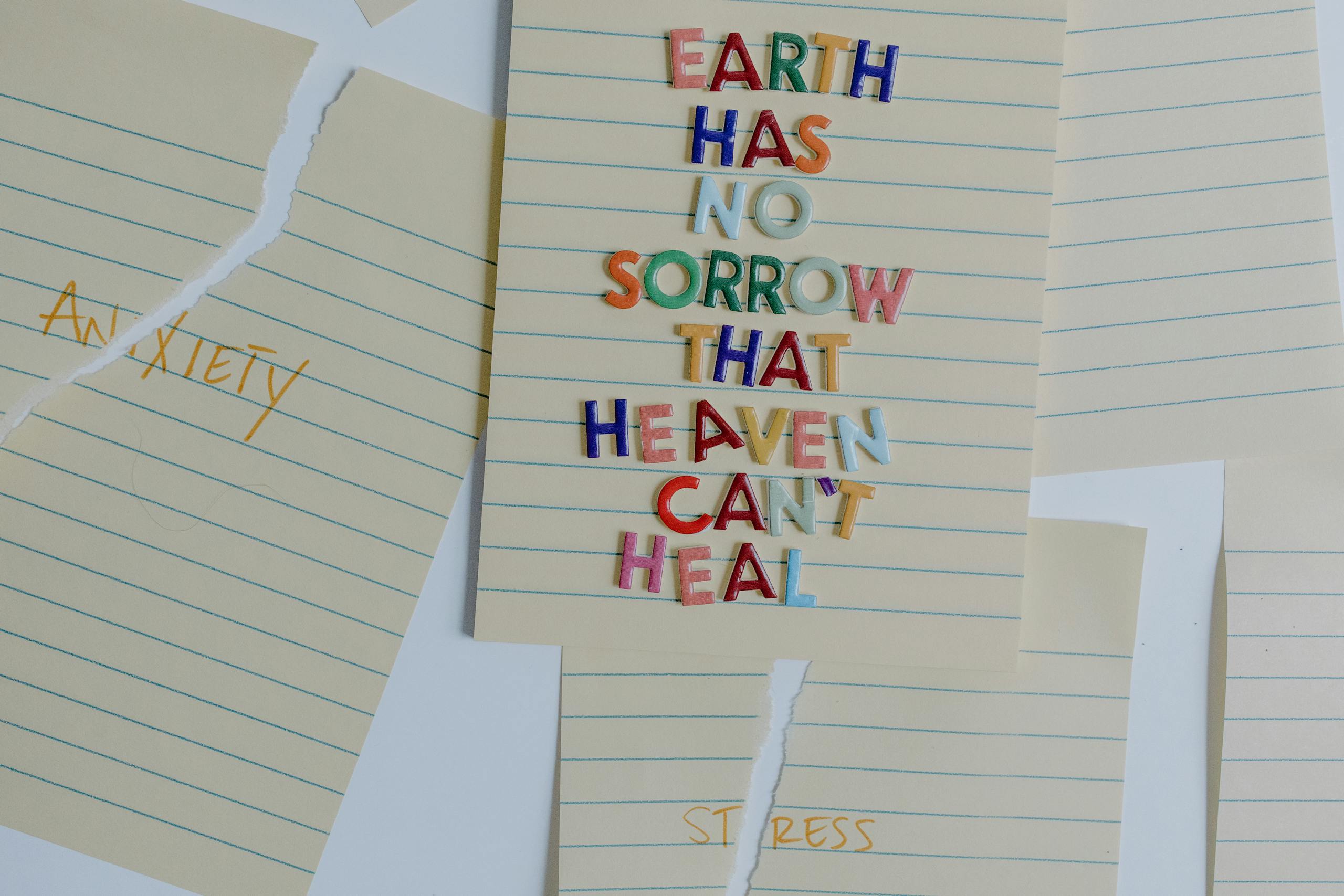 Torn papers with an uplifting quote emphasizing healing and overcoming anxiety and stress.